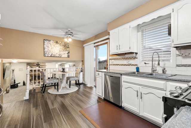 kitchen with tasteful backsplash, sink, white cabinets, stainless steel dishwasher, and gas range