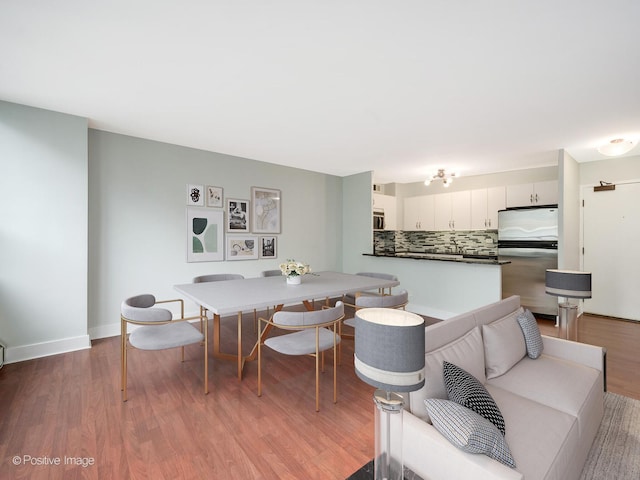 dining room with wood-type flooring and breakfast area