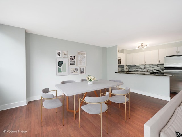 dining space featuring dark hardwood / wood-style flooring