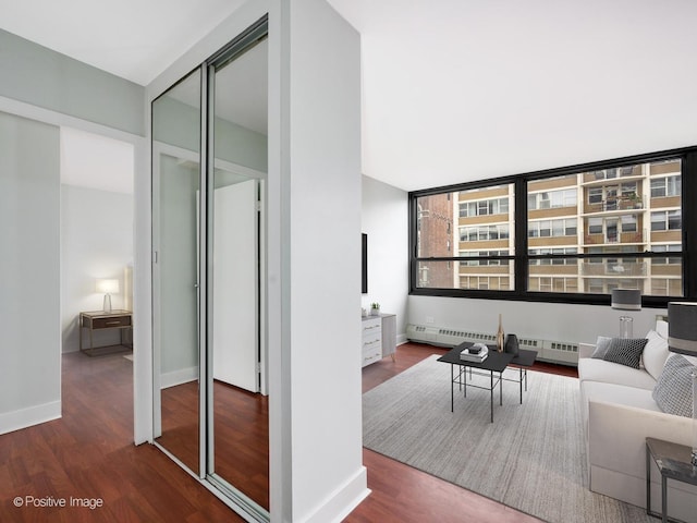 living room with hardwood / wood-style floors and baseboard heating