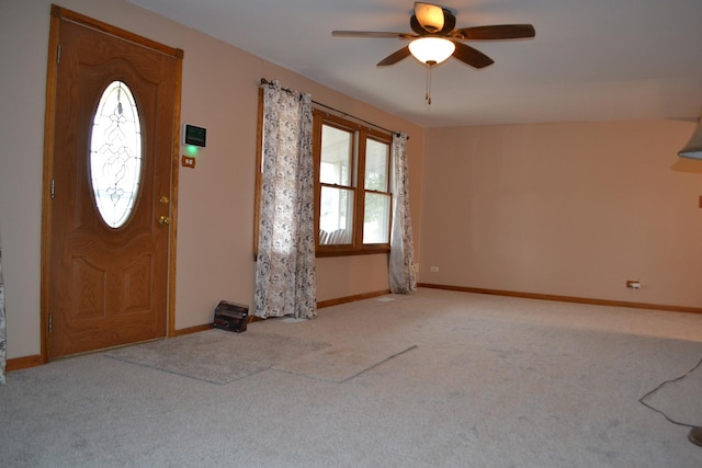 carpeted entryway with ceiling fan