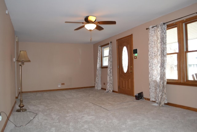 carpeted foyer with ceiling fan