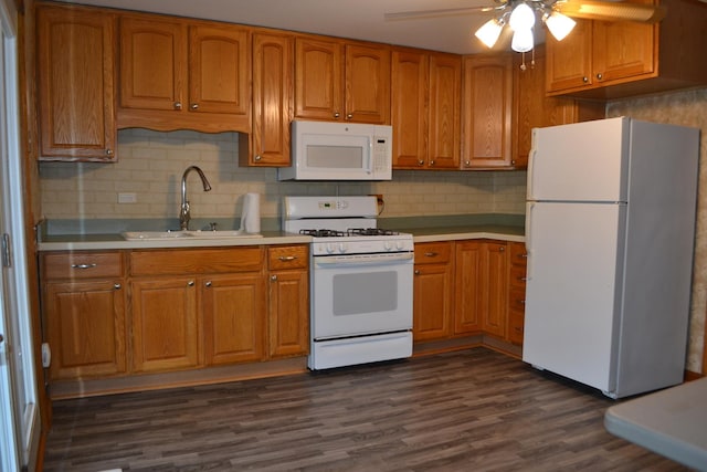 kitchen with sink, white appliances, dark wood-type flooring, ceiling fan, and decorative backsplash