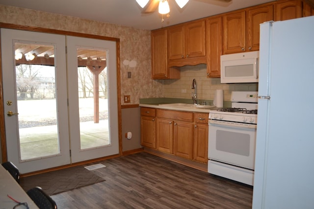 kitchen with sink, white appliances, ceiling fan, dark hardwood / wood-style floors, and tasteful backsplash