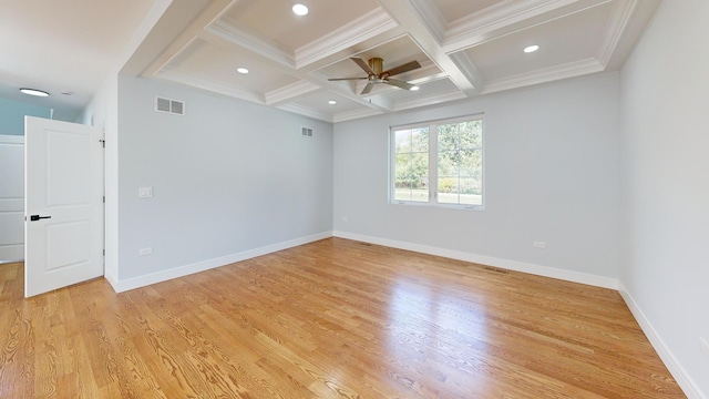 empty room featuring coffered ceiling, light hardwood / wood-style flooring, ornamental molding, ceiling fan, and beam ceiling