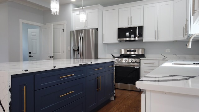 kitchen featuring appliances with stainless steel finishes, decorative light fixtures, blue cabinets, white cabinetry, and dark wood-type flooring