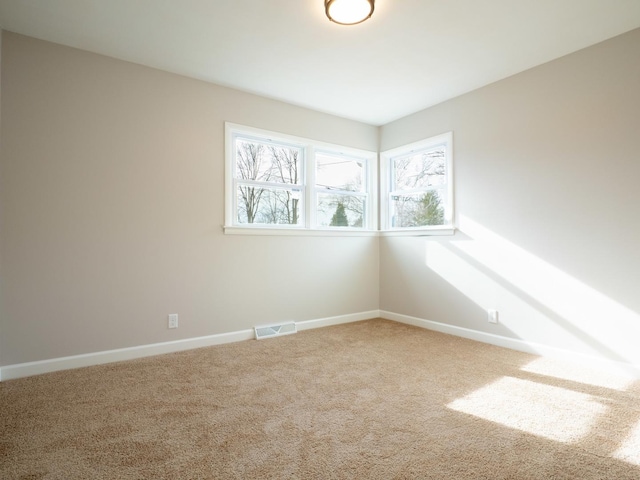 carpeted empty room with plenty of natural light