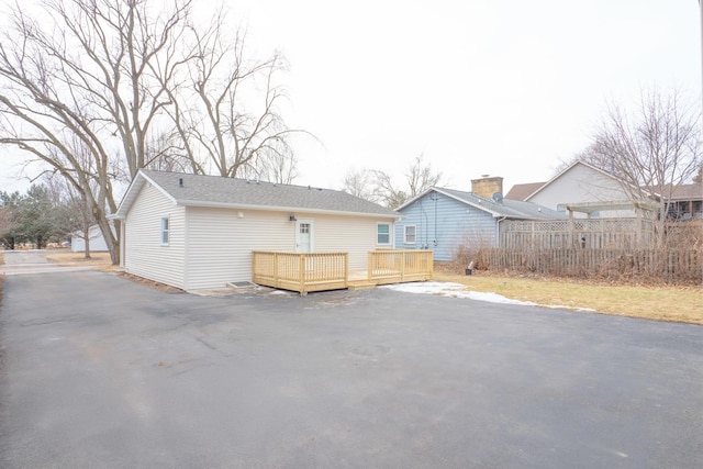 back of house featuring a wooden deck