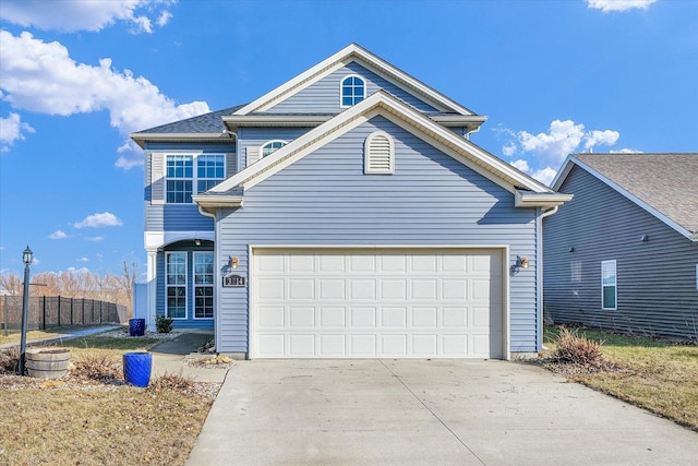 traditional-style house featuring a garage and concrete driveway