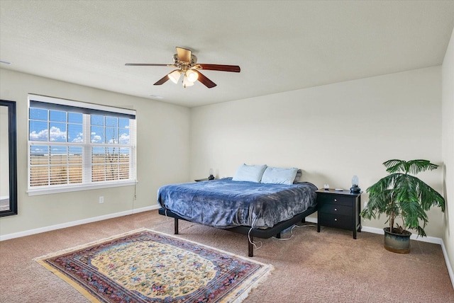 bedroom with ceiling fan, carpet, visible vents, and baseboards