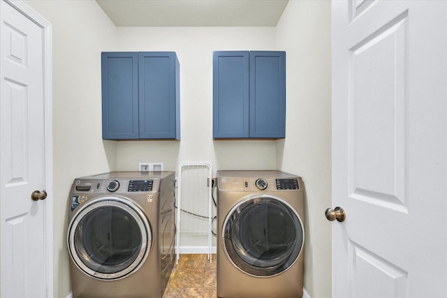 laundry room with cabinet space and washer and clothes dryer