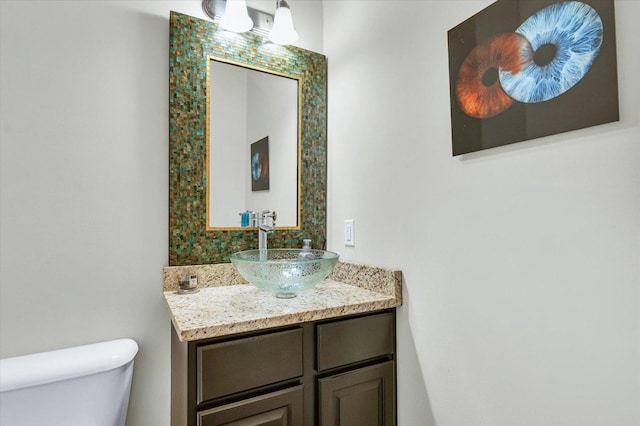 half bath with vanity and toilet