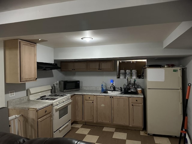 kitchen featuring sink and white appliances