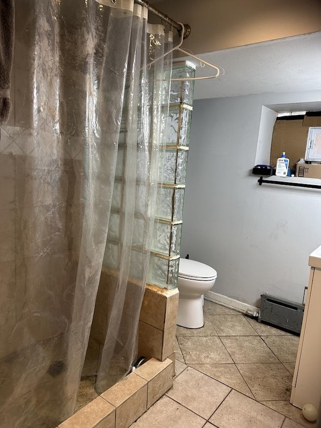 bathroom with tile patterned flooring, toilet, and a shower with shower curtain