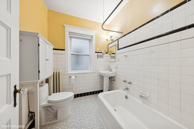 bathroom featuring radiator heating unit, tile walls, tile patterned flooring, toilet, and a bath