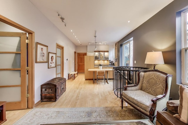 kitchen featuring stainless steel appliances, sink, light hardwood / wood-style floors, and decorative backsplash