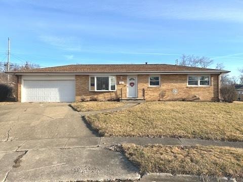 ranch-style home with a garage and a front lawn