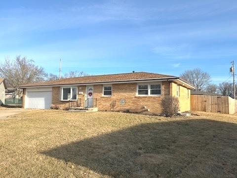 single story home with a garage and a front yard