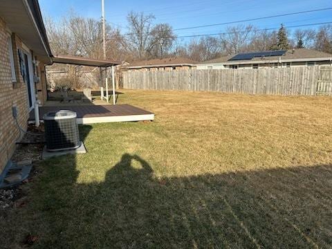 view of yard with a wooden deck and cooling unit