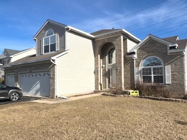 view of front of property featuring driveway, brick siding, and an attached garage