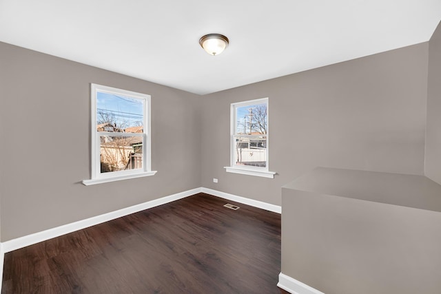 empty room featuring dark hardwood / wood-style flooring