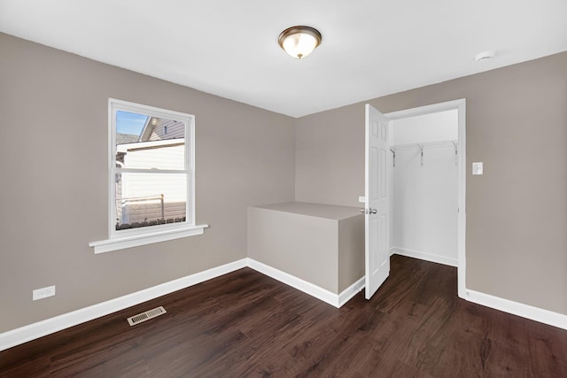 empty room featuring dark hardwood / wood-style flooring