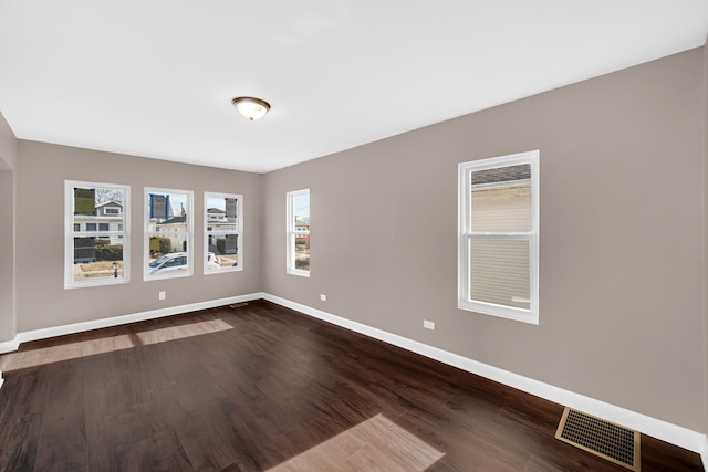 empty room featuring dark wood-type flooring