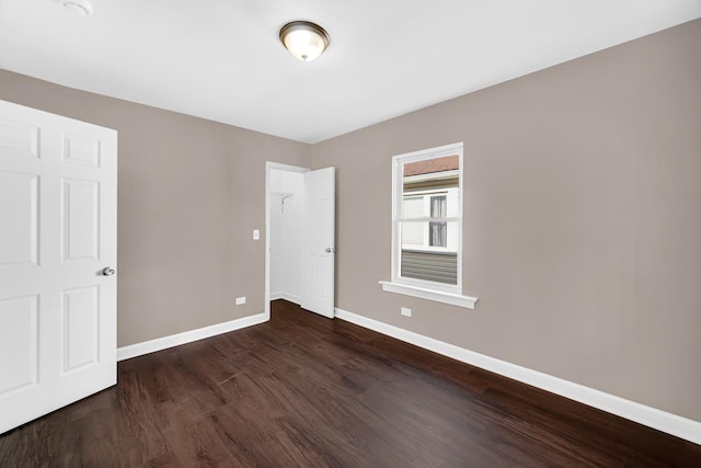 unfurnished bedroom with dark hardwood / wood-style floors