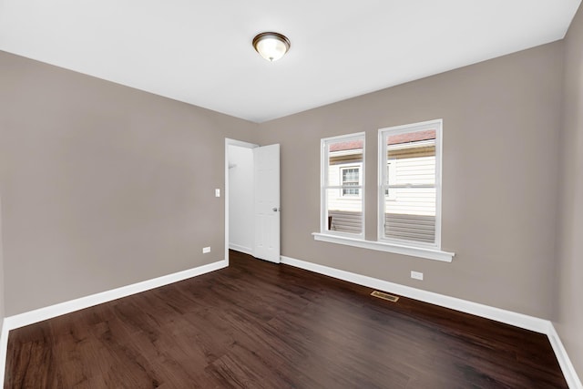 spare room with dark hardwood / wood-style floors