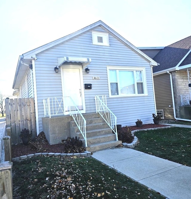 view of front of property with a front yard and fence