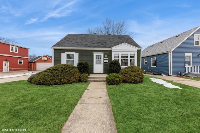 bungalow-style home featuring a garage and a front yard