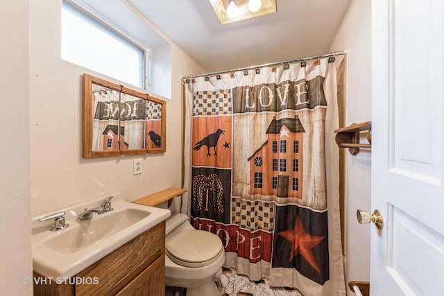 bathroom featuring vanity, toilet, and walk in shower