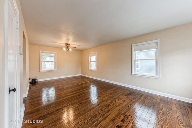 empty room with dark hardwood / wood-style floors and ceiling fan