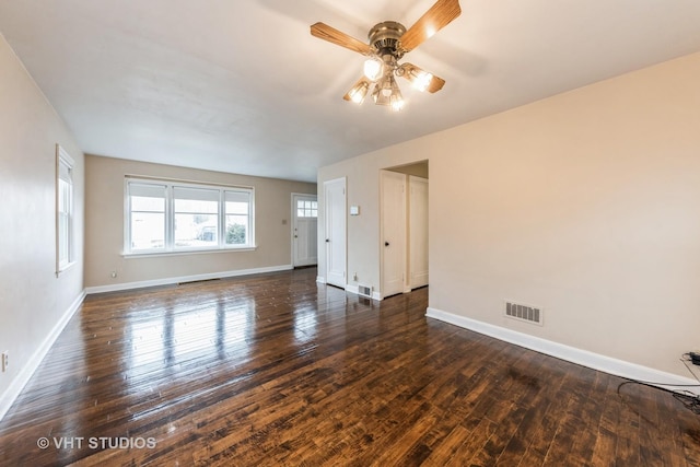 spare room with dark wood-type flooring and ceiling fan