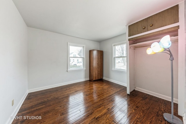 unfurnished bedroom with dark hardwood / wood-style floors