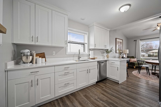 kitchen featuring white cabinetry, dishwasher, sink, kitchen peninsula, and dark wood-type flooring