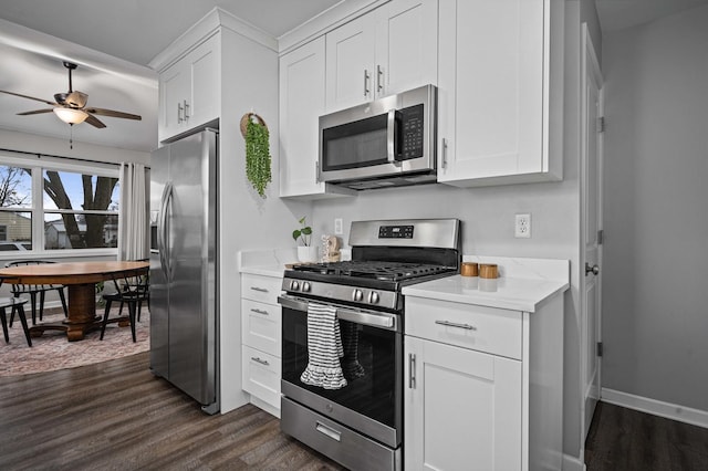 kitchen with white cabinetry, dark hardwood / wood-style flooring, stainless steel appliances, and ceiling fan