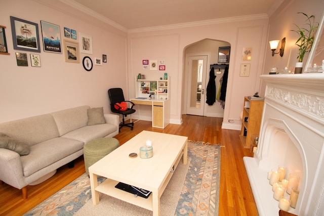 living room with wood-type flooring and ornamental molding