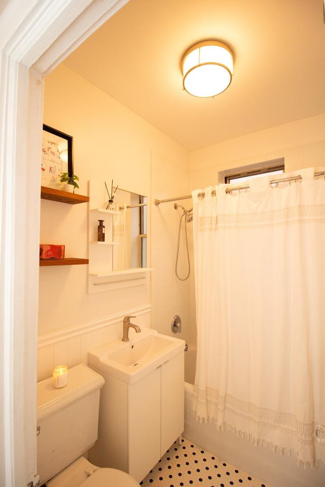 full bathroom with vanity, shower / tub combo with curtain, and toilet