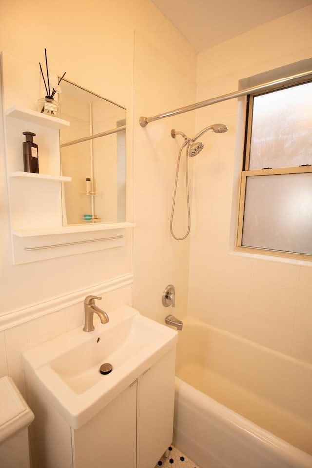 bathroom with vanity and tiled shower / bath combo