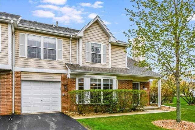 view of front of home featuring a garage and a front lawn