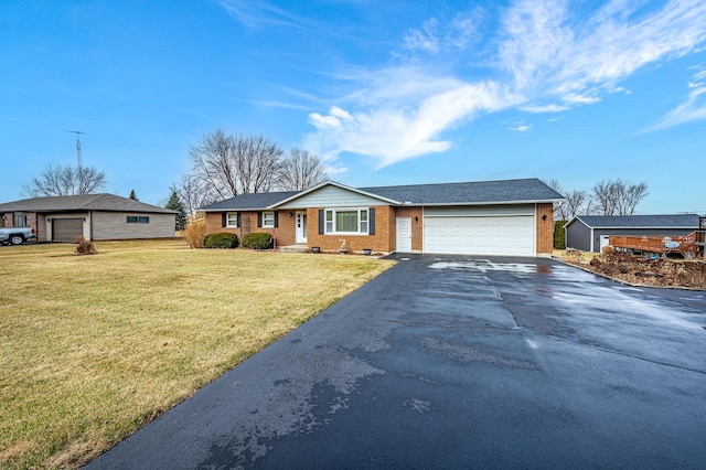 single story home with a garage and a front lawn