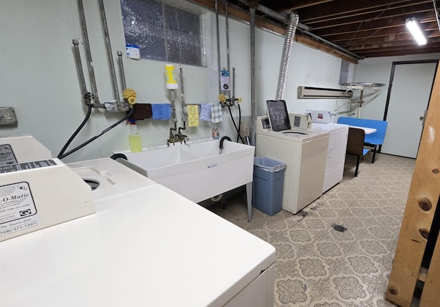 washroom featuring separate washer and dryer and sink