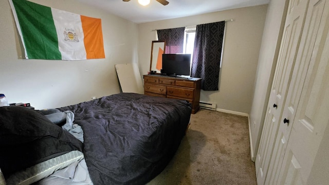 bedroom featuring light carpet, ceiling fan, and baseboard heating