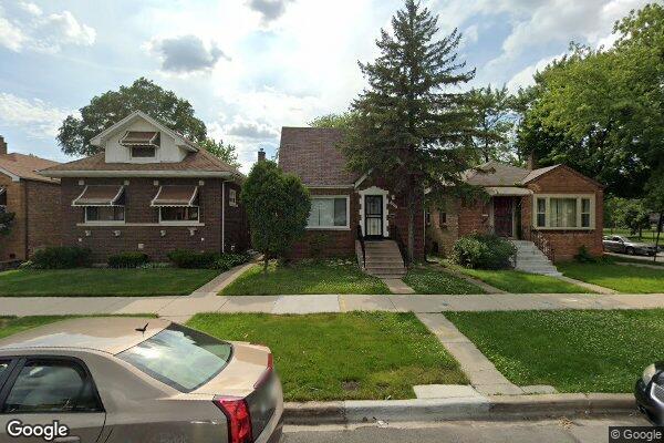 bungalow-style home with a front lawn