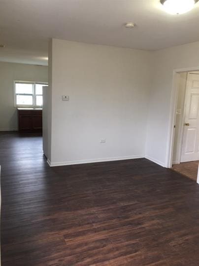 empty room with dark wood-type flooring