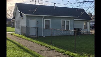 rear view of house featuring a yard