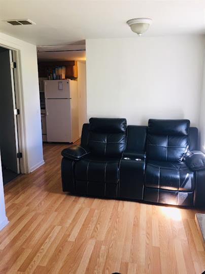 home theater room with wood-type flooring