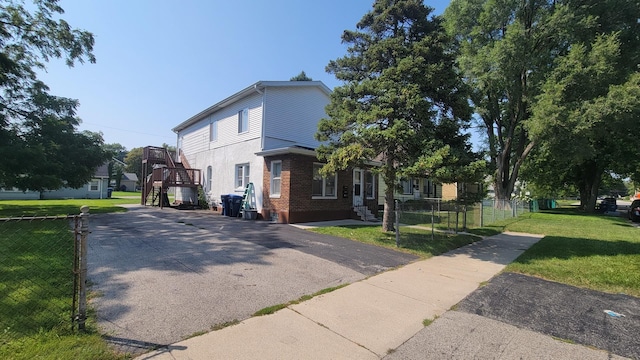 view of property exterior with a lawn