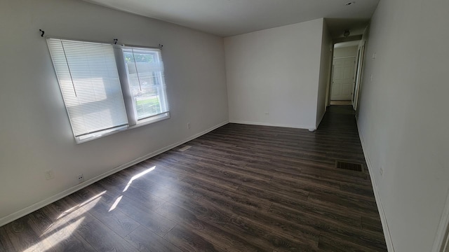 unfurnished room featuring dark hardwood / wood-style floors